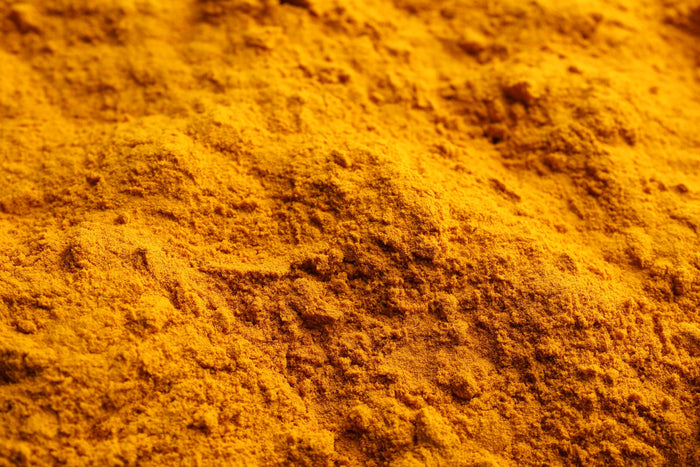 Macro photograph of turmeric powder texture