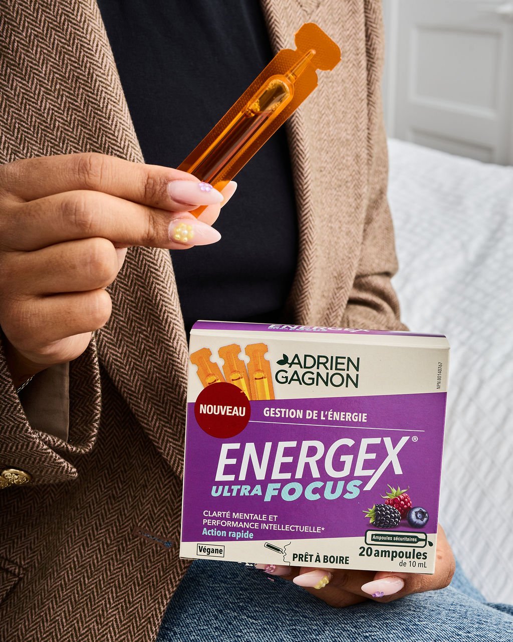 Hand holding an Energex Ultra Focus vial above its box